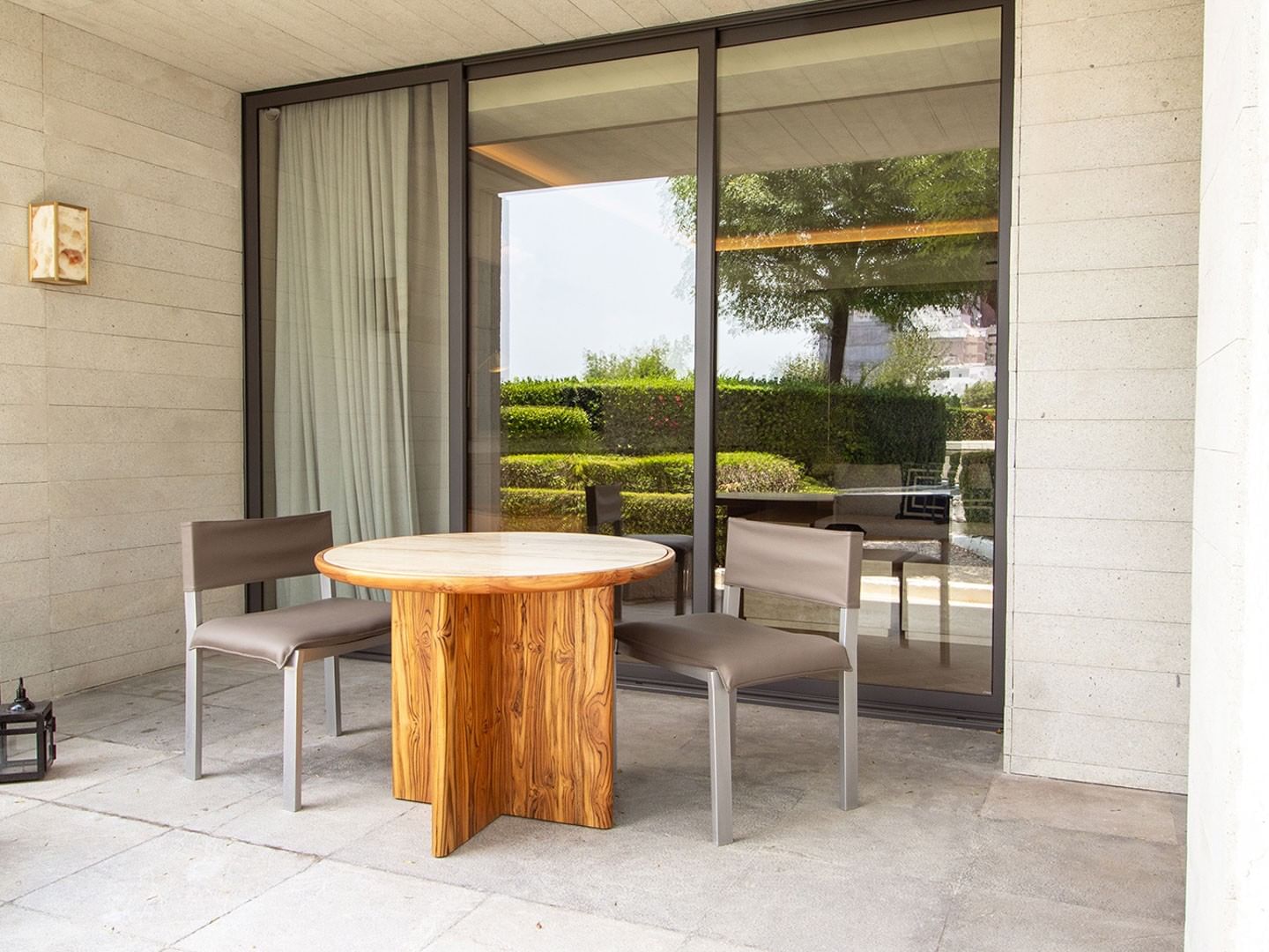 King Superior Viceroys Suite patio with a round table, grey chairs, and garden views at Camino Real Polanco Mexico
