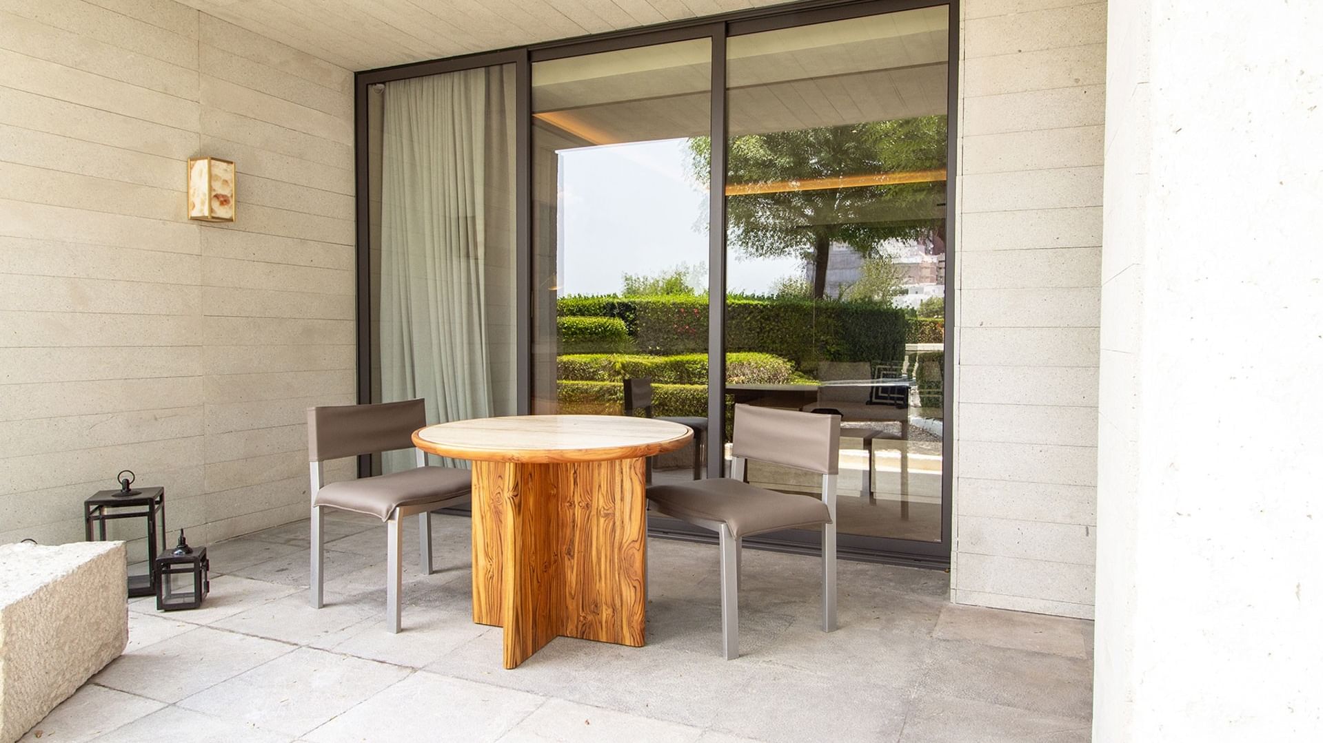 King Superior Viceroys Suite patio with a round table, grey chairs, and garden views at Camino Real Polanco Mexico
