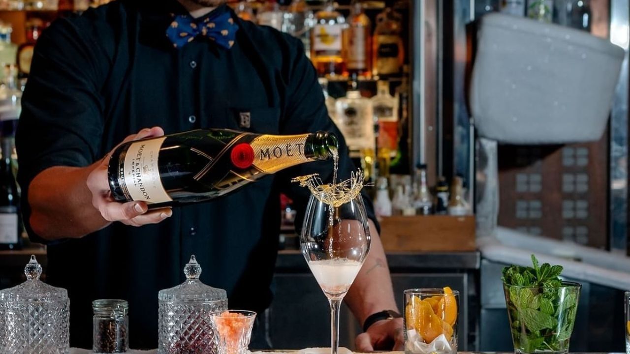 Bartender pouring champagne at Whistler bar