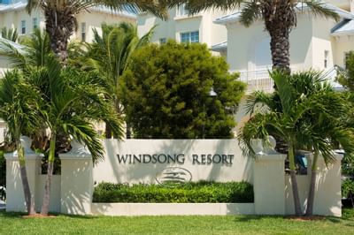 Windsong resort sign and trees at Windsong Resort On The Reef