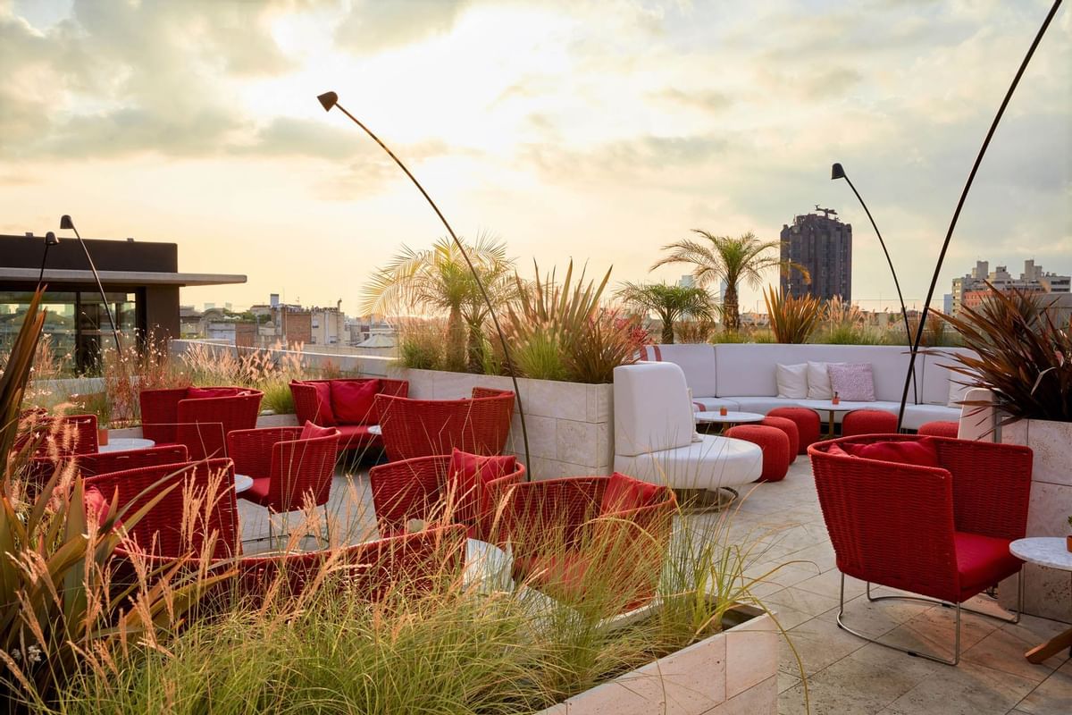 A rooftop lounge area during the sunset at Almanac X Prague