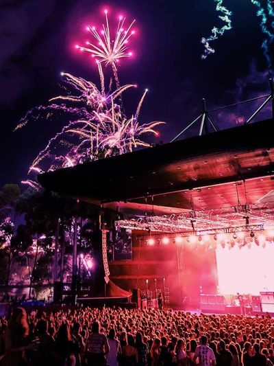 Outdoor concert with fireworks in the night sky above a crowd at Riverstage near Sofitel Brisbane Central