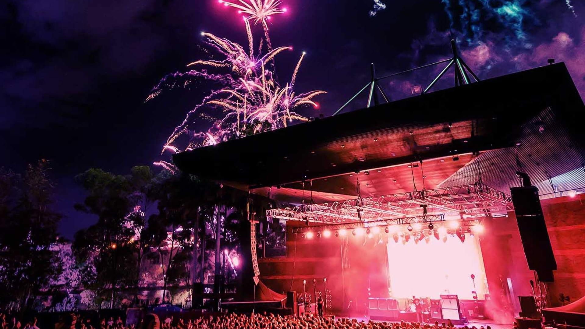 Outdoor concert with fireworks in the night sky above a crowd at Riverstage near Sofitel Brisbane Central
