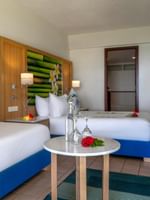 Comfortable Ocean View Room with two beds and a table at The Naviti Resort Korolevu.