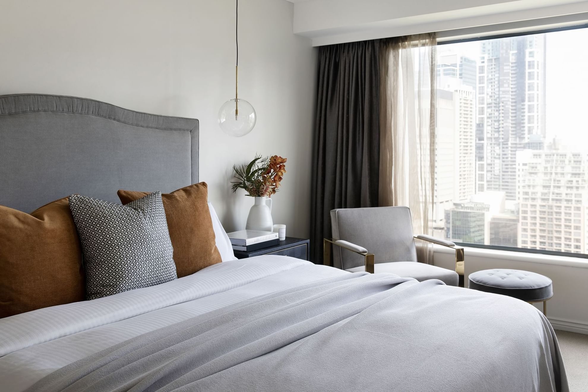 Lounger & nightstand by the bed in Park Suite by Coco Republic at Pullman Sydney Hyde Park