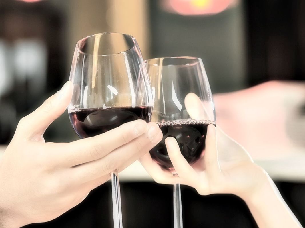 Couple clinking glasses of red wine