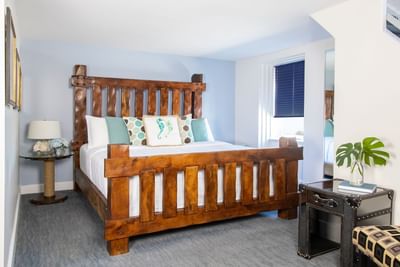 Comfy wooden bed, lamps & beside table in Superior Loft Sail Inn at Retro Suites Hotel