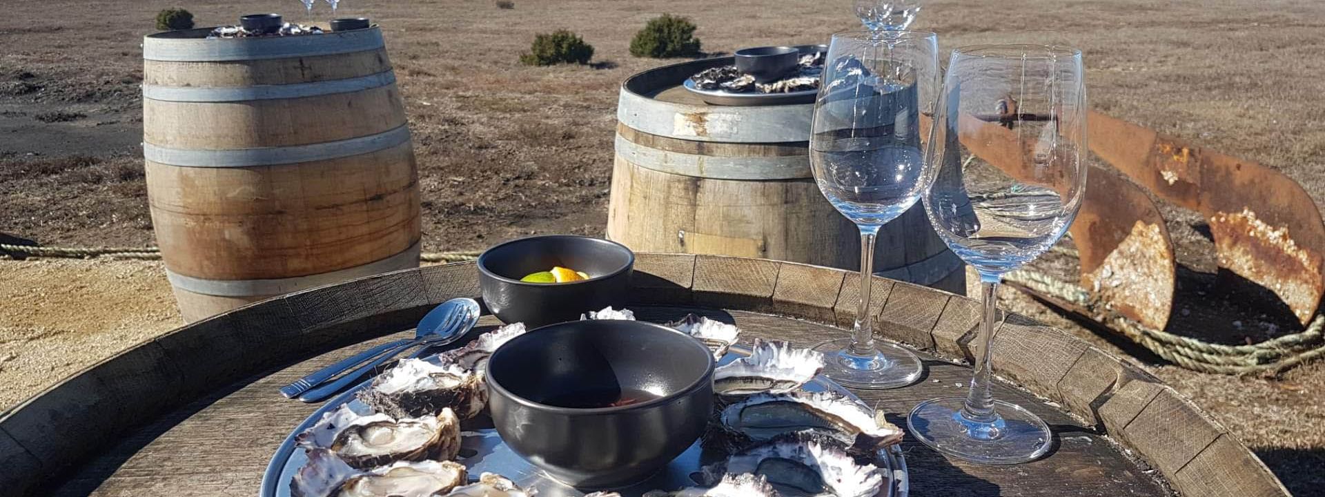 Close-up of Oysters dish & glasses overlooking the Bay near Freycinet Lodge