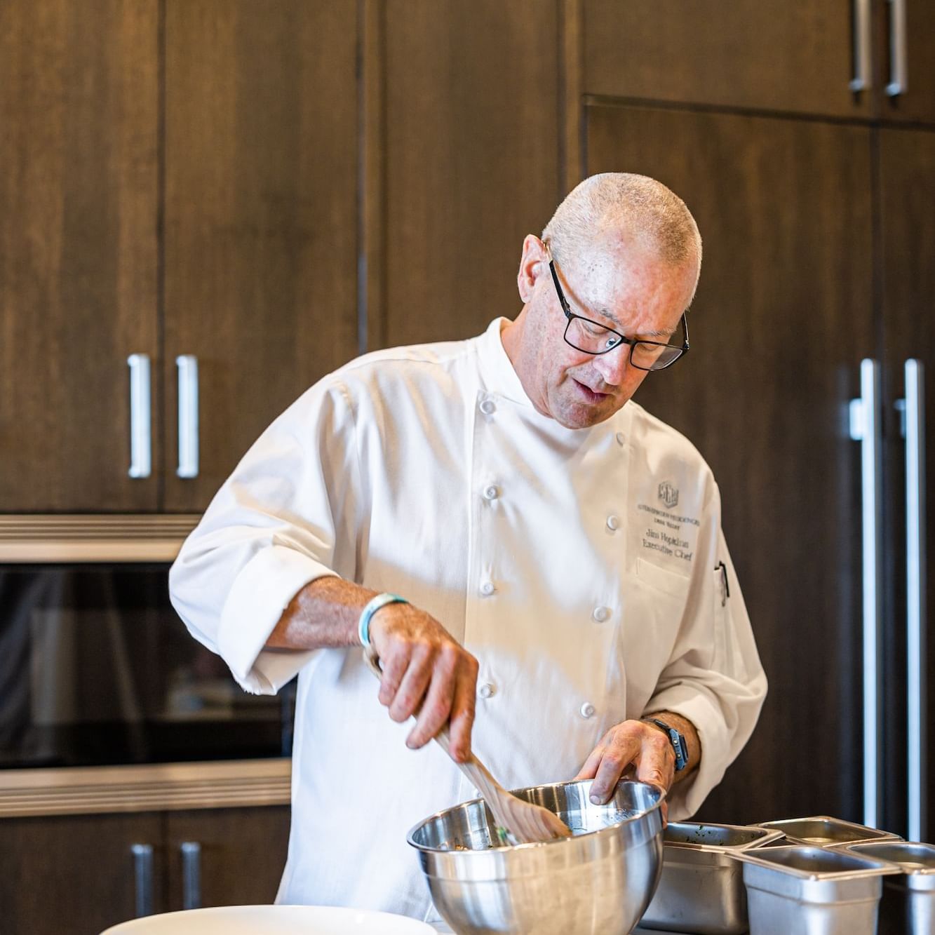 Chef Jim Hopkins cooking in a kitchen at Stein Eriksen Residences