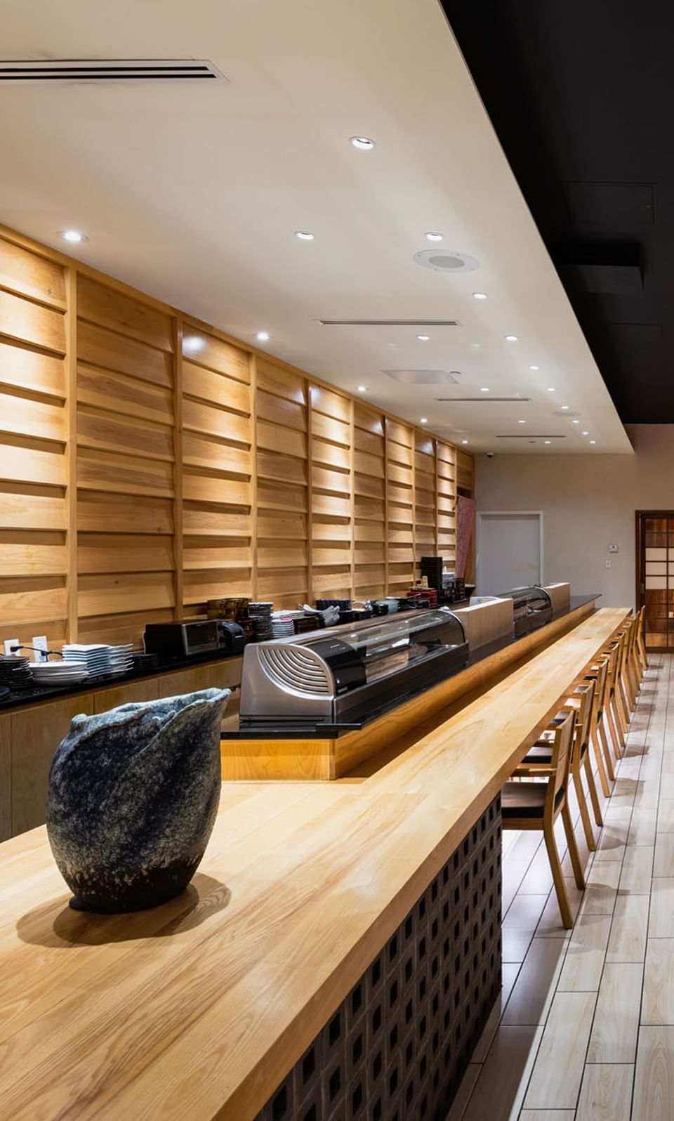 Aoi Japanese Restaurant interior with wooden furniture and bar counter at APA Hotel Woodbridge