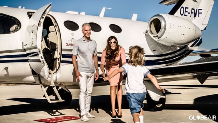 Family getting on a private jet near Falkensteiner Schlosshotel Velden