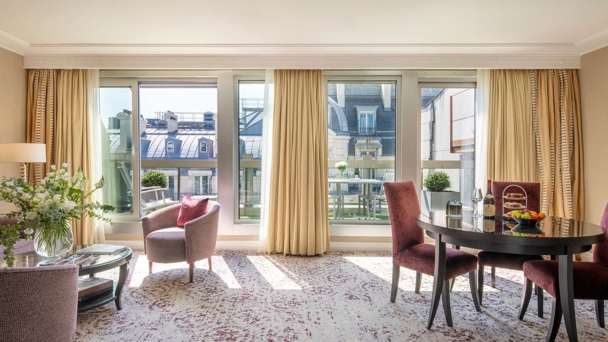 Elegant hotel suite with panoramic view and modern furnishings featuring Pay 3, Stay 4 offer.