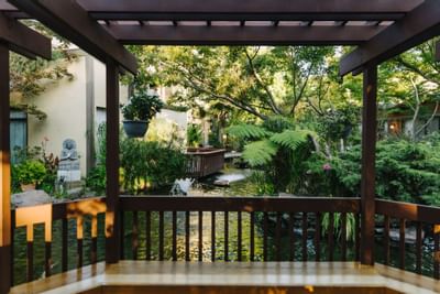 Lounge area with a pond view at Dinah's Garden Hotel