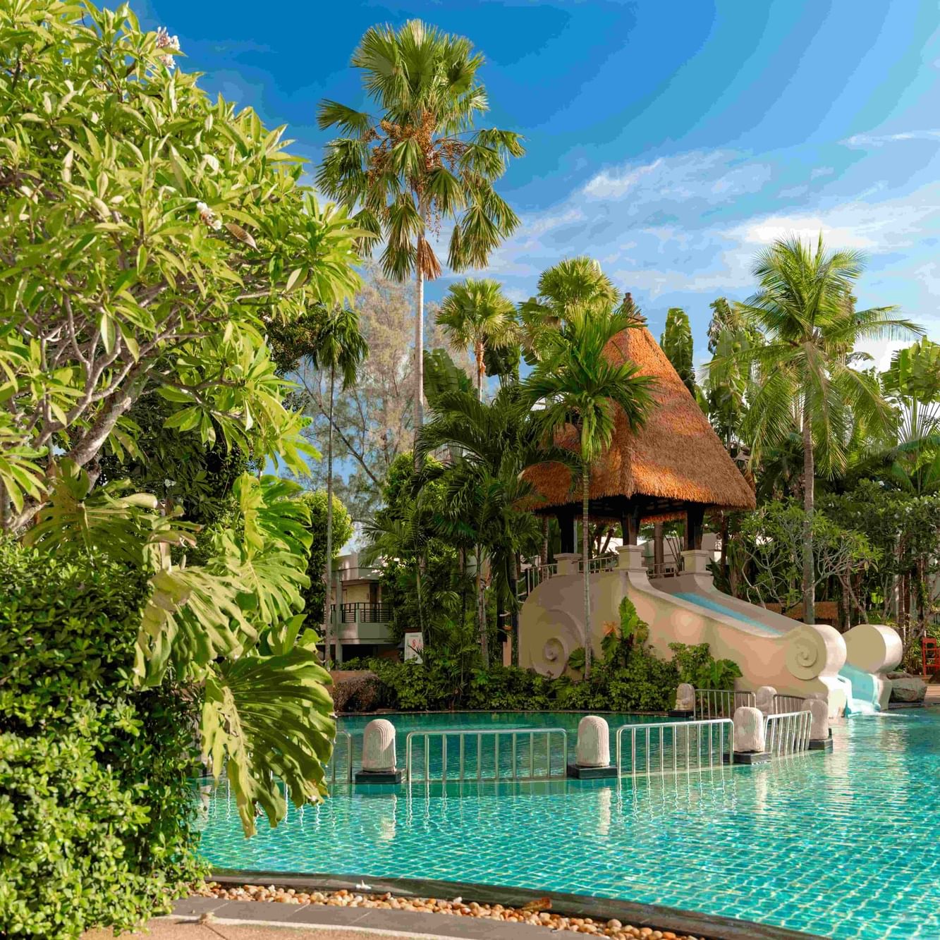 Paradox Resort Phuket’s Main Pool with 1.2m depth, kids' pool, and water slide