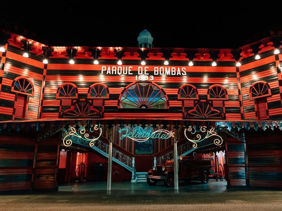 Exterior view of Parque de Bombas entrance at night near Las Casitas Village