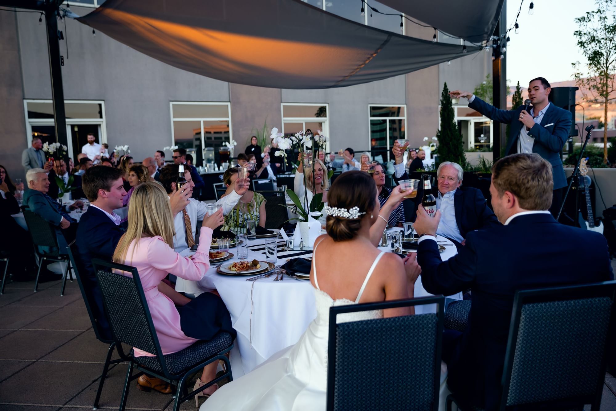 People cheering at a wedding on a Terrace at The Grove Hotel