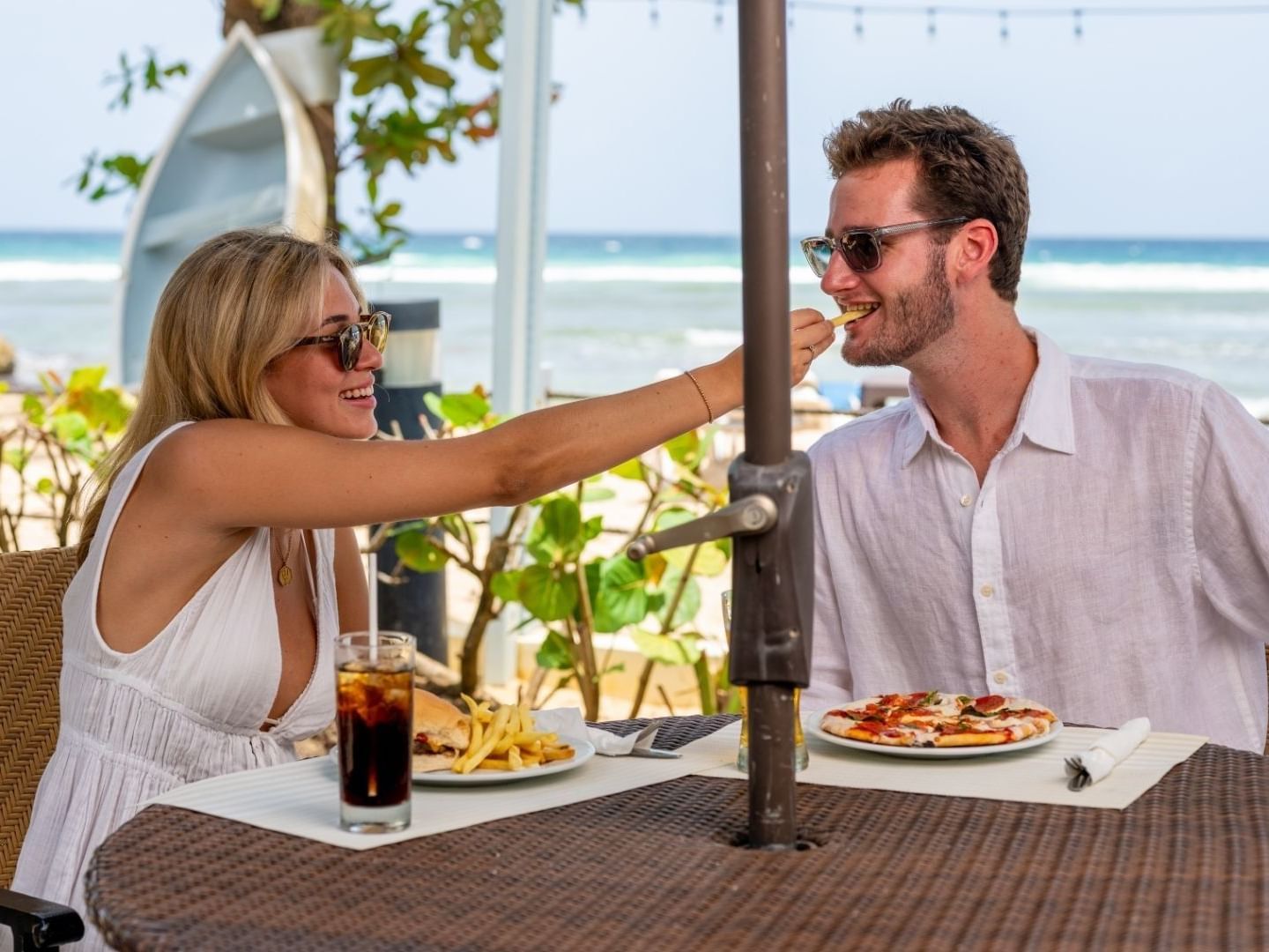 Couple dining with ocean view and beach setting at Savannah Beach Hotel.