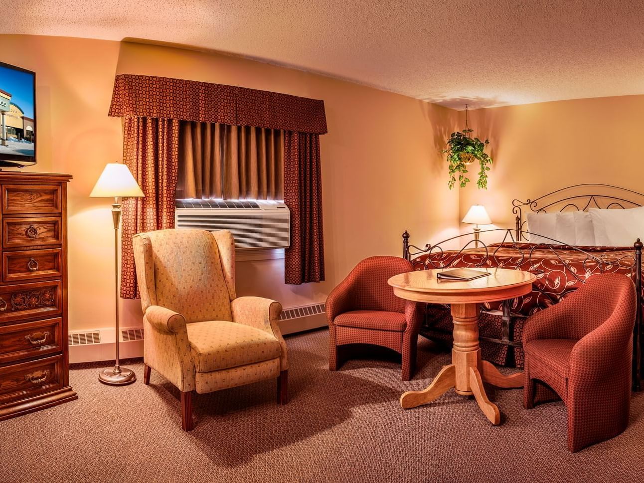 room with bed, accent chairs and dining table