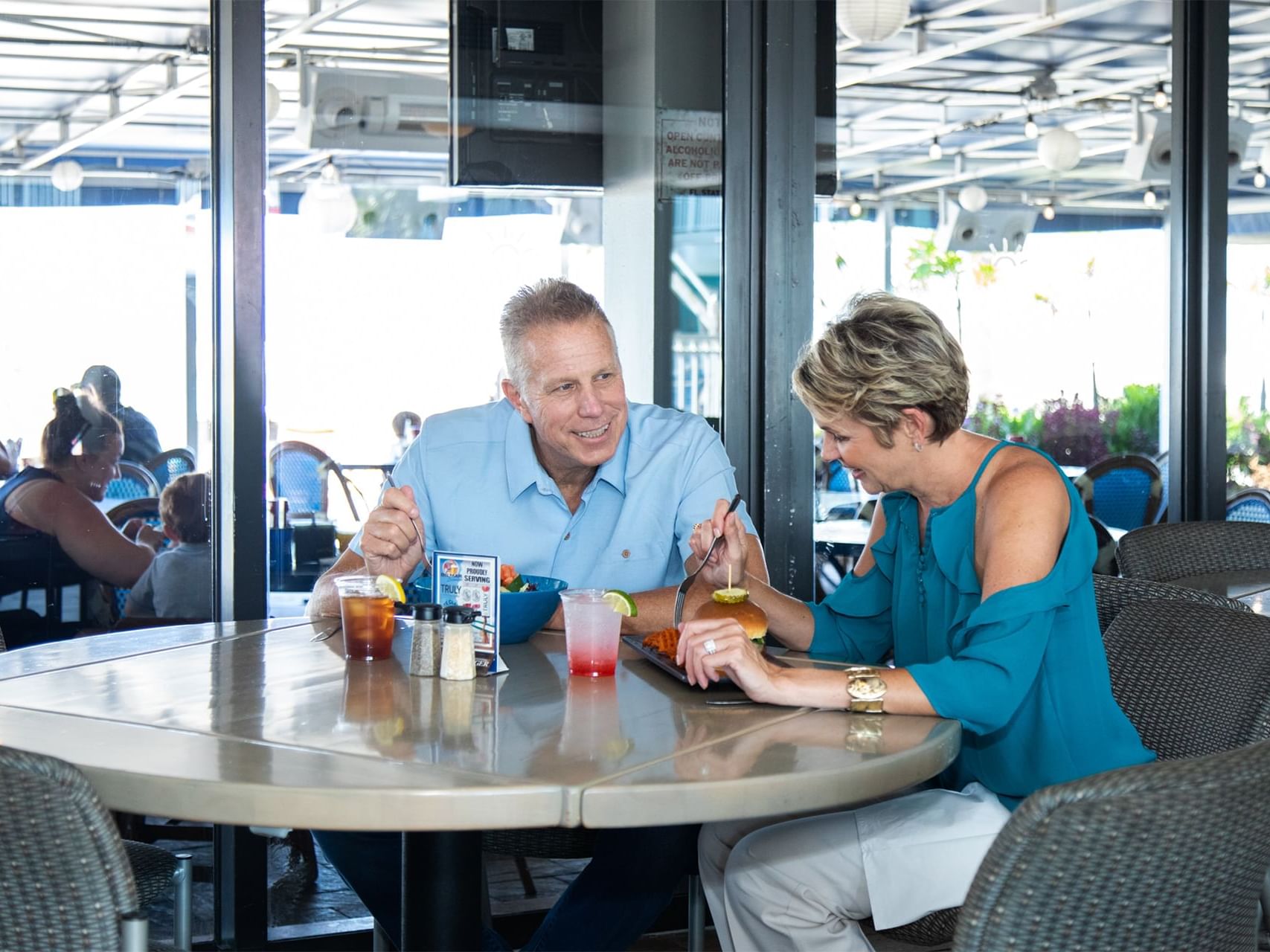 Elderly couple dining at a restaurant at Bilmar Beach Resort
