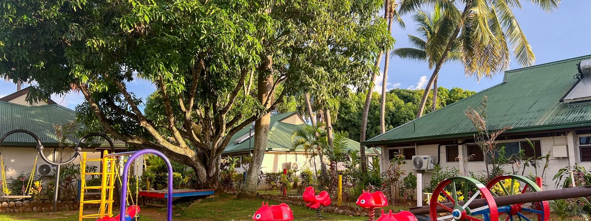 Colorful kids club playground with swings and slides at Tokatoka Resort in Nadi, Fiji.