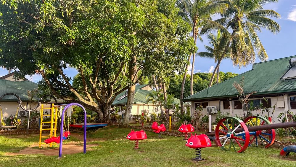 Colorful kids club playground with swings and slides at Tokatoka Resort in Nadi, Fiji.