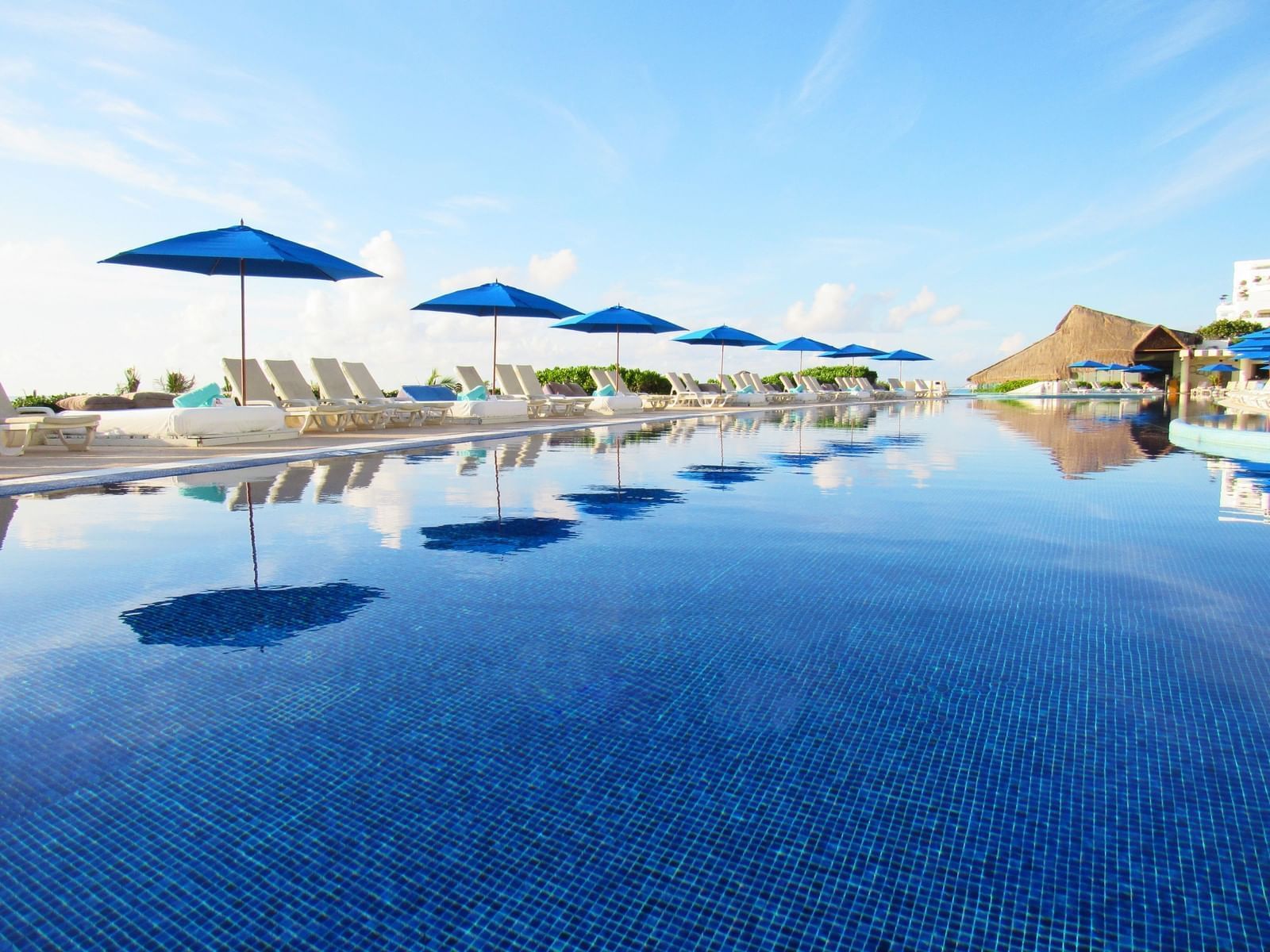 Poolside and sun beds at Live Aqua Beach Resort Cancun