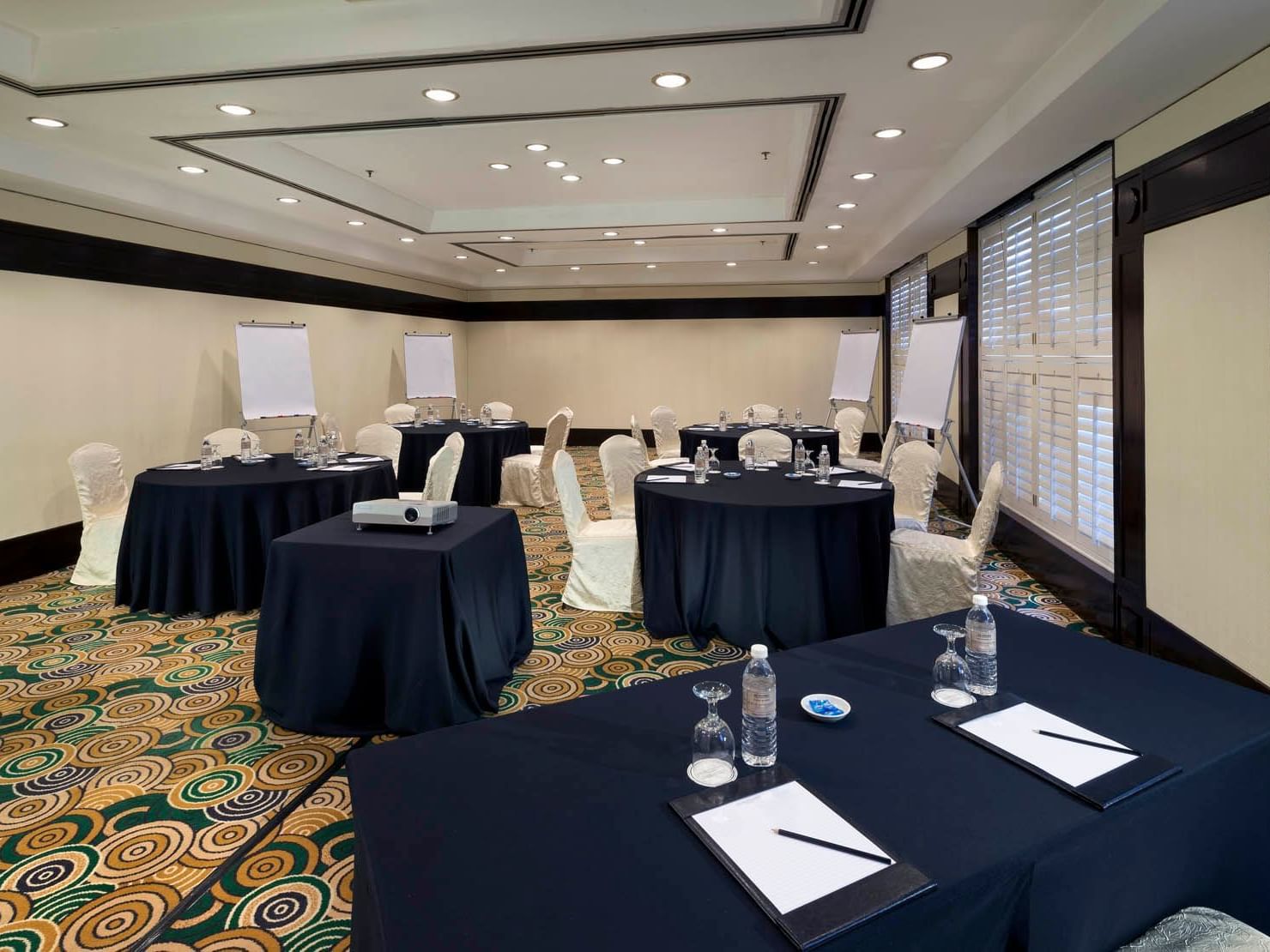 Interior of Baiduri meeting room with banquet tables and carpeted floors at Saujana Hotel Kuala Lumpur