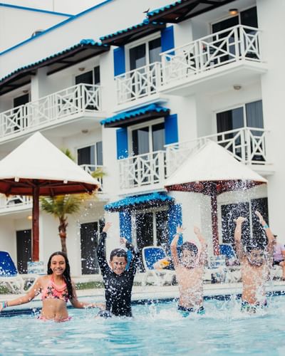 Kids playing in the outdoor pool at Playa Blanca Beach Resort
