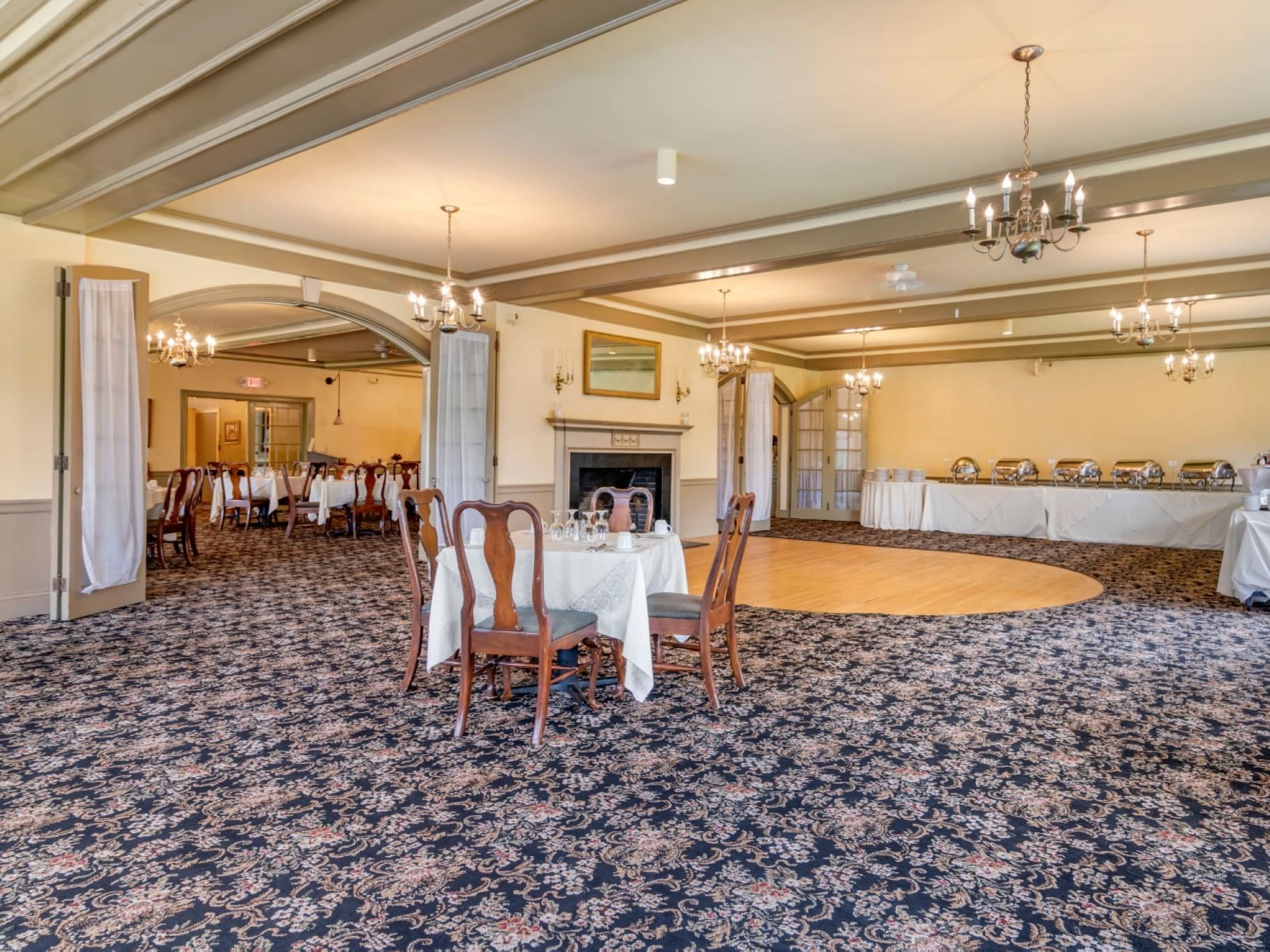 Table set up & buffet area in Gibson Room with carpeted floors at The Bethel Inn Resort & Suites