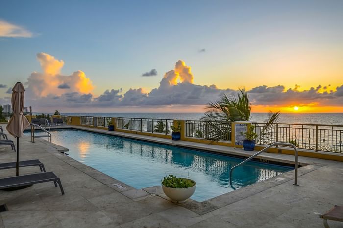 Outdoor swimming pool with lounge chairs and palm tree in one of the luxury hotel fort lauderdale at Atlantic Hotel & Spa