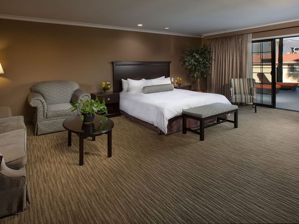 King bed in hotel suite with living area