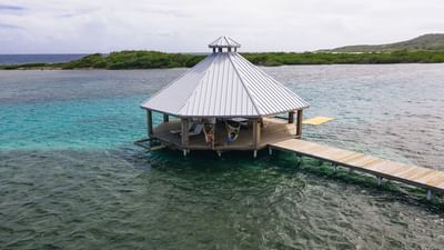 Guests relaxing in hammocks under a water gazebo at Barefoot Cay Resort & Marina