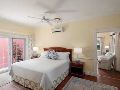 Cozy bed arranged on the carpeted floor in Deluxe Suite at Royal Palms Hotel