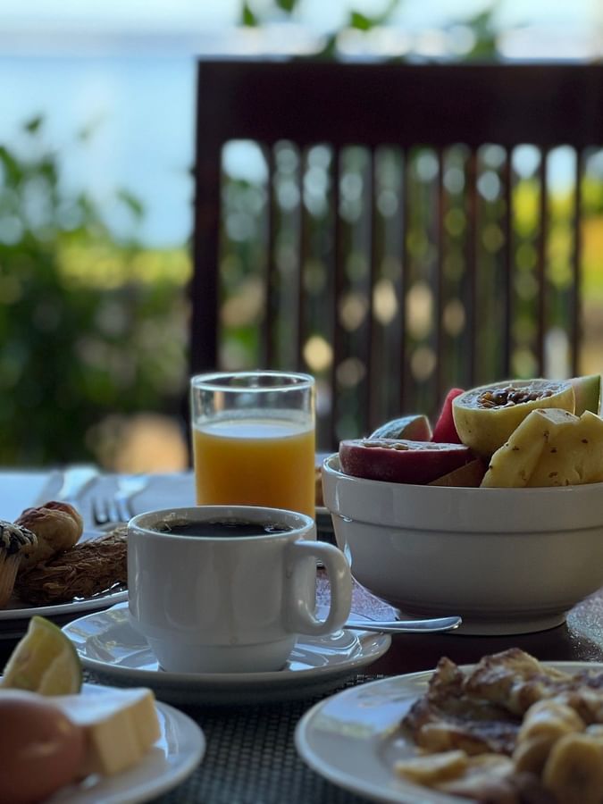 Plates with breakfast food and fruit bowl at Bula Brasserie, Warwick Fiji Resort and Spa in Korolevu