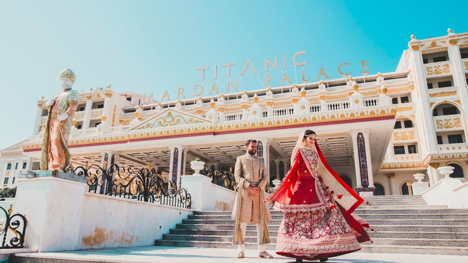 Punjabi wedded couple posing for an image outdoors on a sunny day at Titanic Mardan Palace