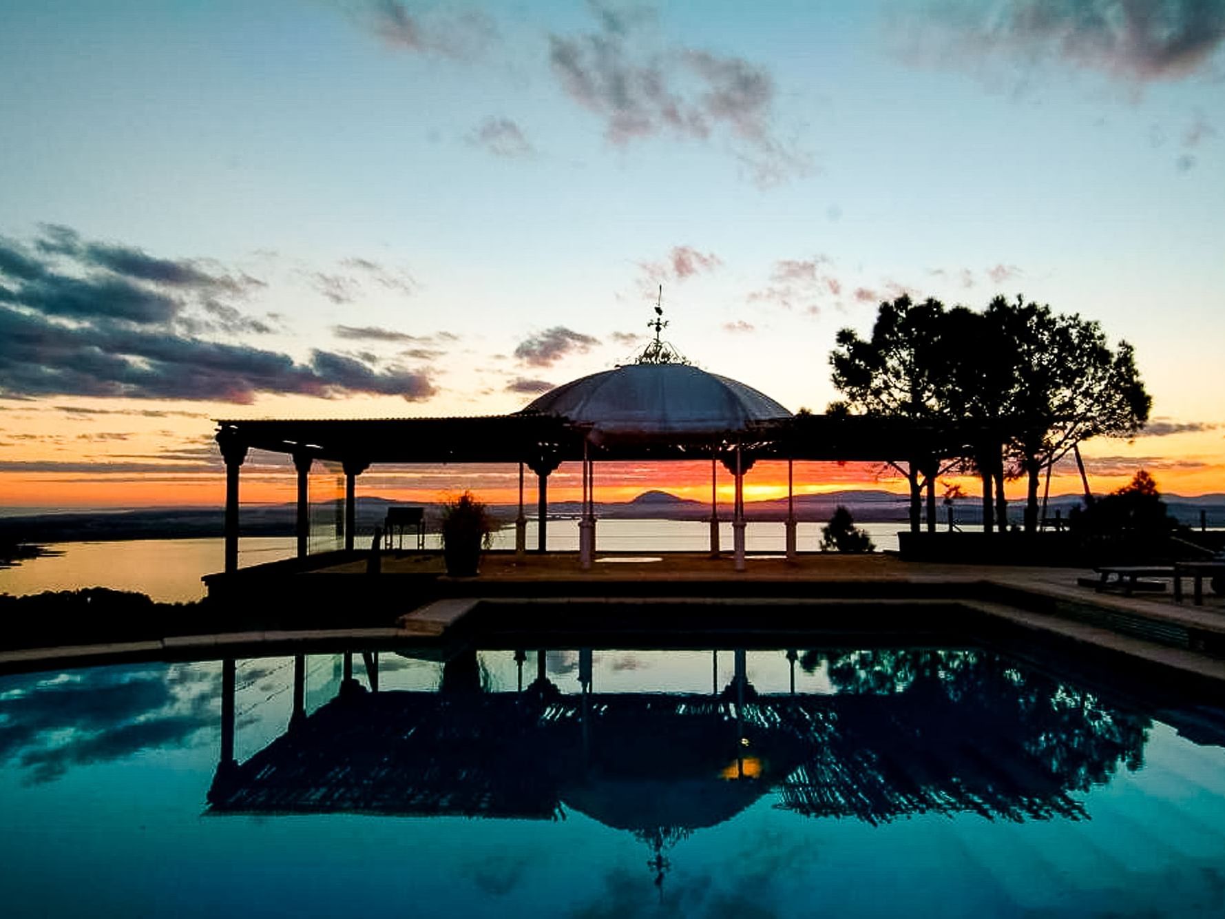 A panoramic view of the swimming pool & sunset at DOT Hotels