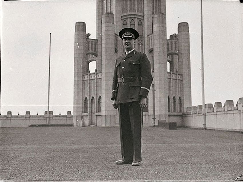 Greyscale picture of a man in uniform standing on a rooftop near The Grace Sydney