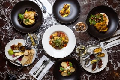An inviting overhead view of a table with several fine dining dishes at the Royal on the Park Hotel