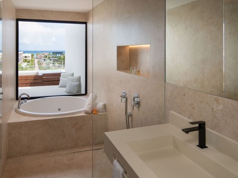 Vanity and tub with window view in Fuego Suite Partial Ocean view at Live Aqua Resorts and Residence Club