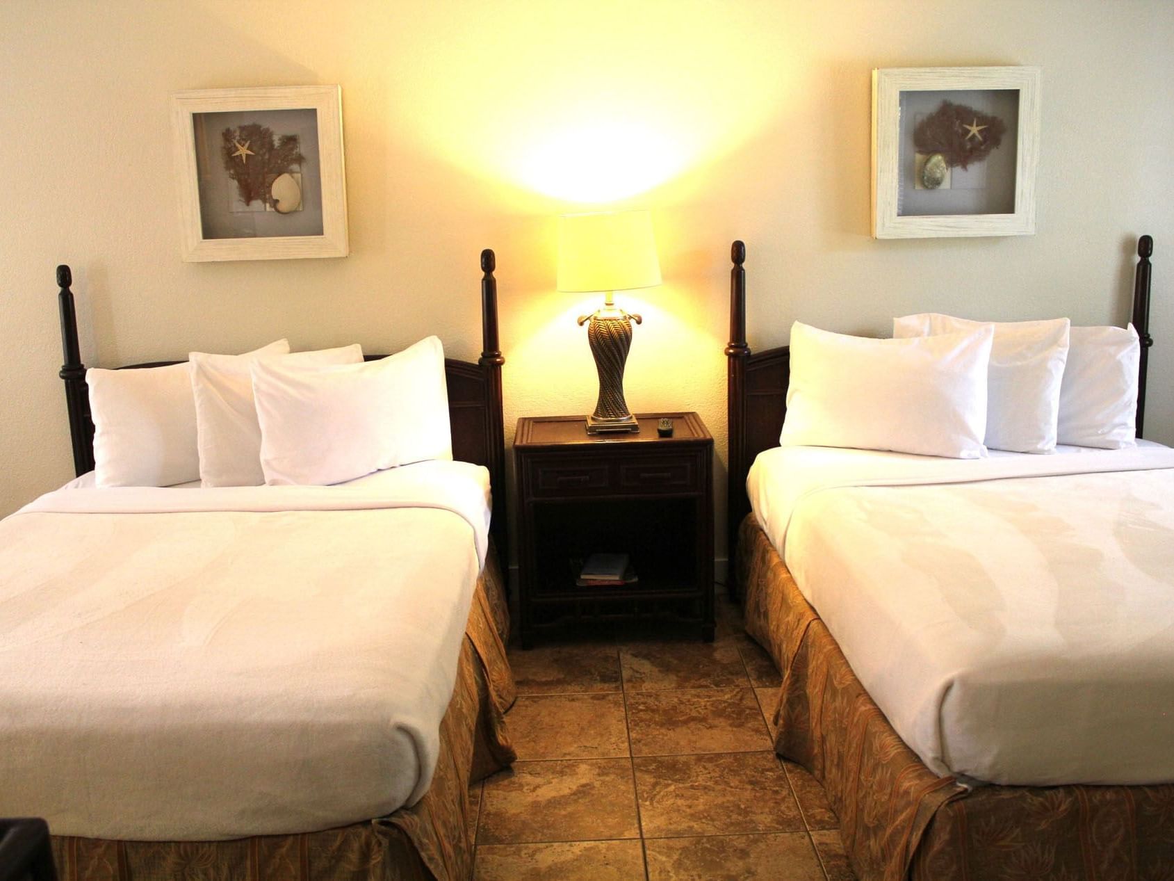 Two queen beds with nightstands & wall art in the Ocean Breeze Deluxe Suite at Ocean Lodge Boca Raton