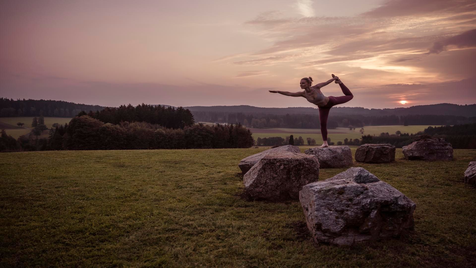 A woman doing a yoga pose near Falkensteiner Genuss & Wohlfühlhotel Mühlviertel