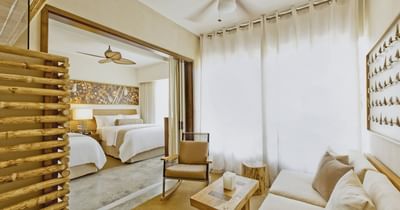 Nesto Suite with natural wood accents and bedroom area at El Mangroove Hotel