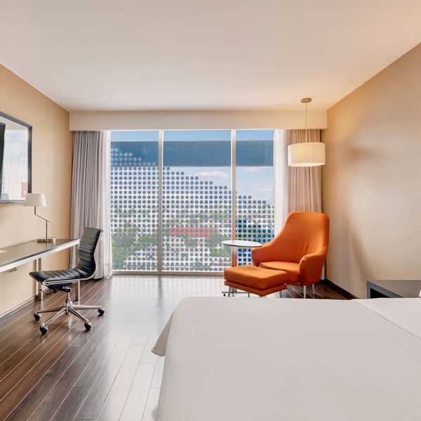 Bed, desk & lounge in Executive Room, 1 king at Fiesta Inn