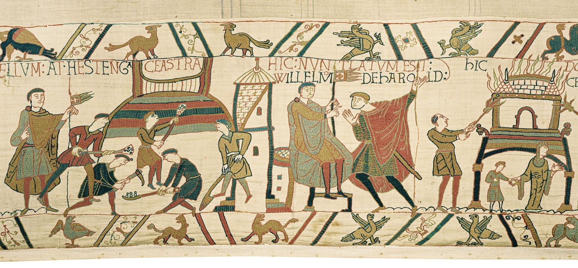 Medieval tapestry depicting figures in period dress engaged in construction and conversation with Latin text.