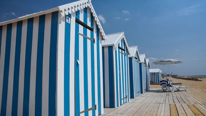 A row of beach cabins at a beach near the Originals Hotels