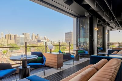 Lavish interior & decor with an outdoor view in IO Rooftop Lounge at Godfrey Hotel Detroit