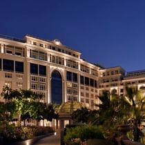Exterior view of the hotel at night at Palazzo Versace Dubai