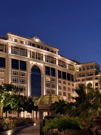 Exterior view of hotel at night from garden at Palazzo Versace 