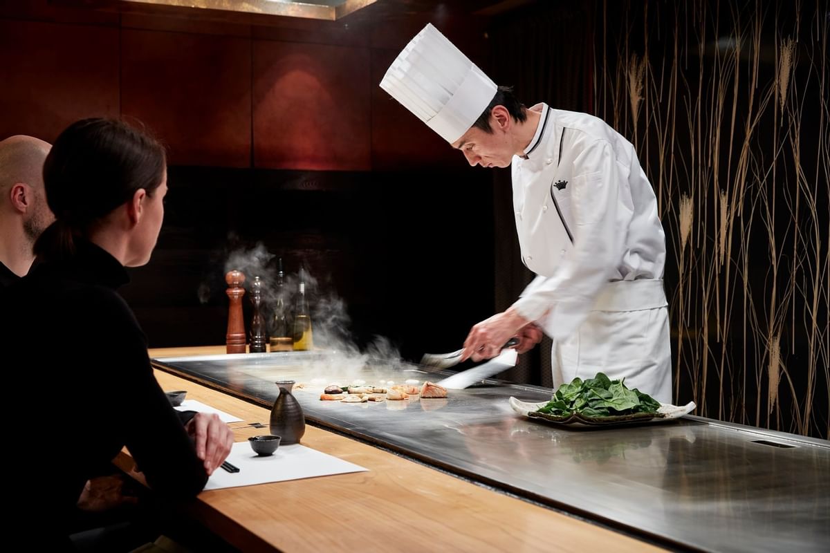 Chef preparing a dish in Koko at Crown Hotel Melbourne