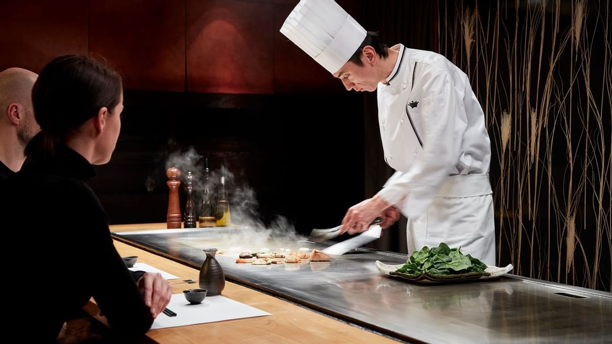 Chef preparing a dish in Koko at Crown Hotel Melbourne